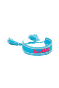 Blue woven bracelet with pink “MIAMI” lettering and fringe tassel ends
