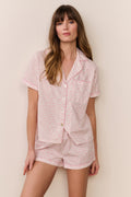 Pink patterned polo pajama short set with button-up top and matching shorts, front view