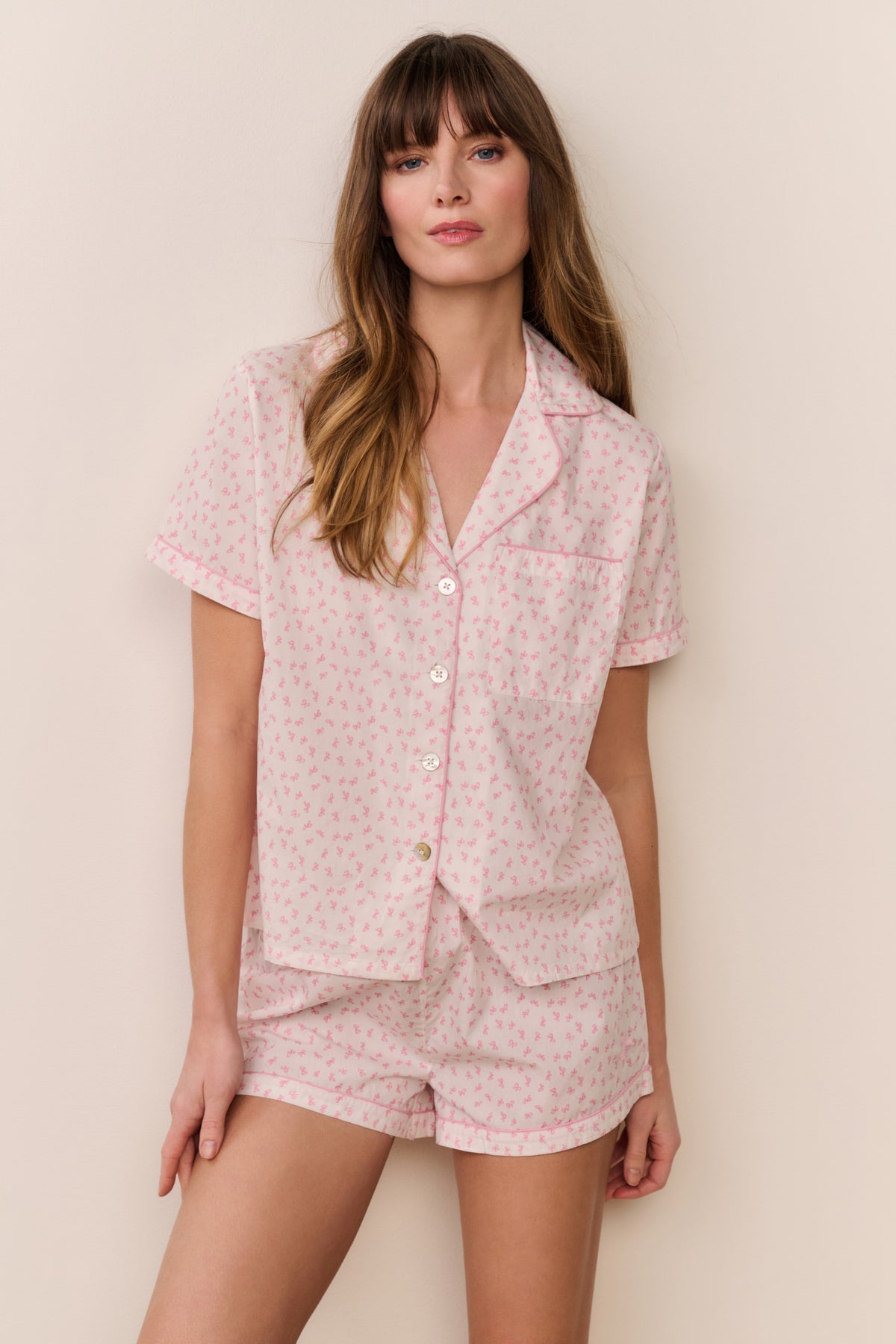 Pink patterned polo pajama short set with button-up top and matching shorts, front view