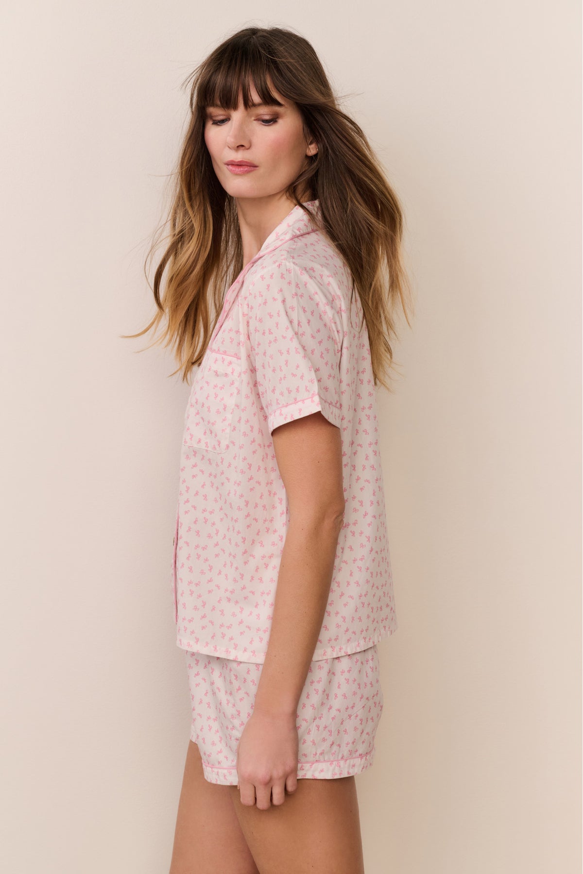Pink patterned polo pajama set with button-front top and short shorts, side view