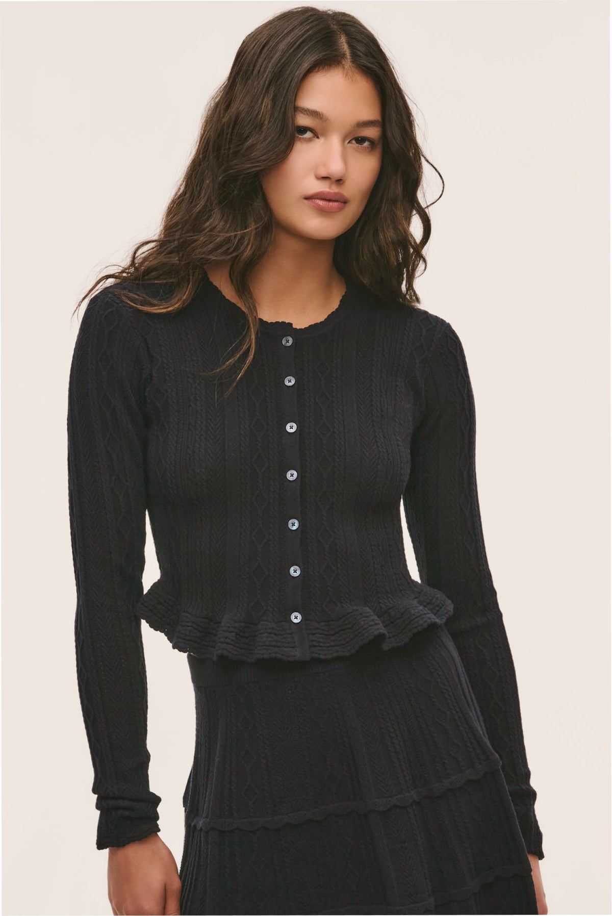 Dark pointelle stretch cardigan with button placket and ruffled cuffs, long sleeves