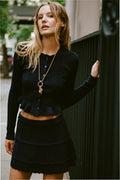 Dark pointelle stretch cardigan with button front and layered ruffle hem, long sleeve