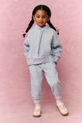 Girls' mini hoodie front view, light blue small print, pouch pocket and drawstring hood