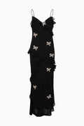 Black sleeveless mini dress with tiered ruffles and bow appliques, flat lay