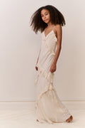 Ivory V-neck maxi dress with asymmetrical ruffle detail and spaghetti straps