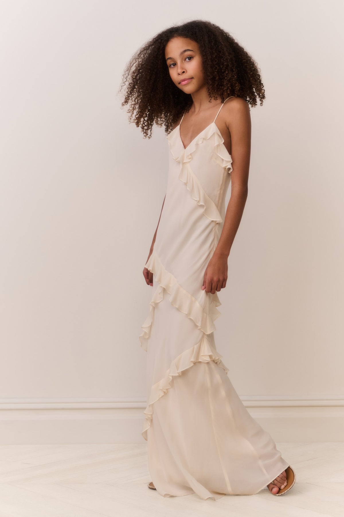 Ivory V-neck maxi dress with asymmetrical ruffle detail and spaghetti straps
