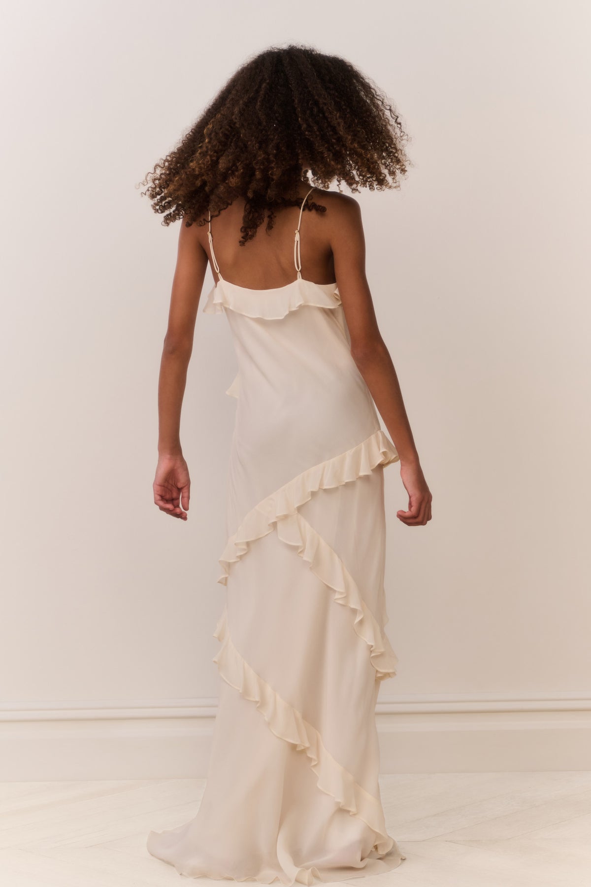 Ivory sleeveless maxi dress with layered ruffles and spaghetti straps