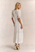 White maxi dress with lace-look texture and tiered skirt, back/side view