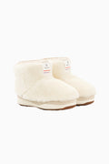Pair of off-white girls boots shown at an angle with faux-fur exterior and sole