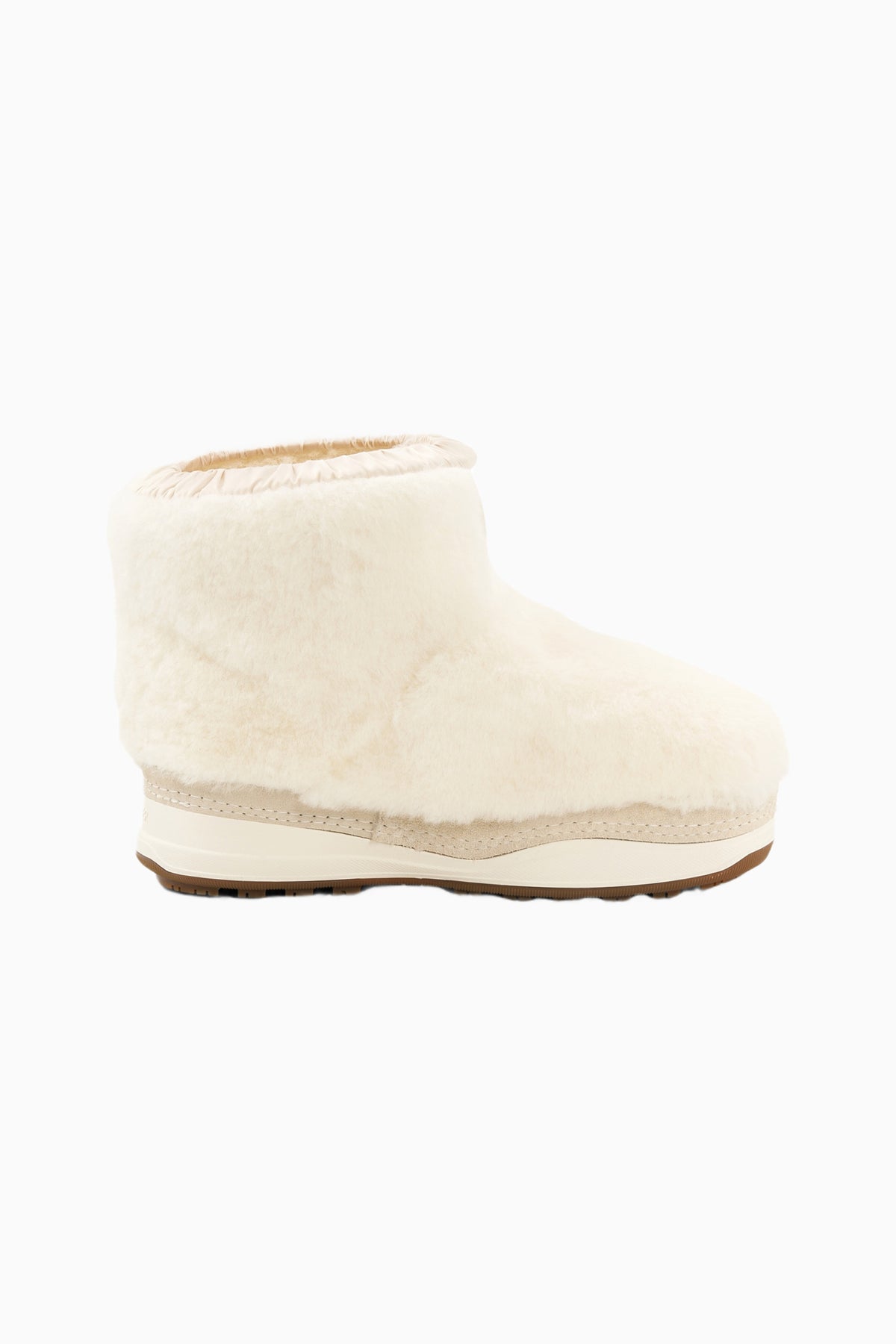 Off-white girls boot in side profile with plush cuff and contrast light sole