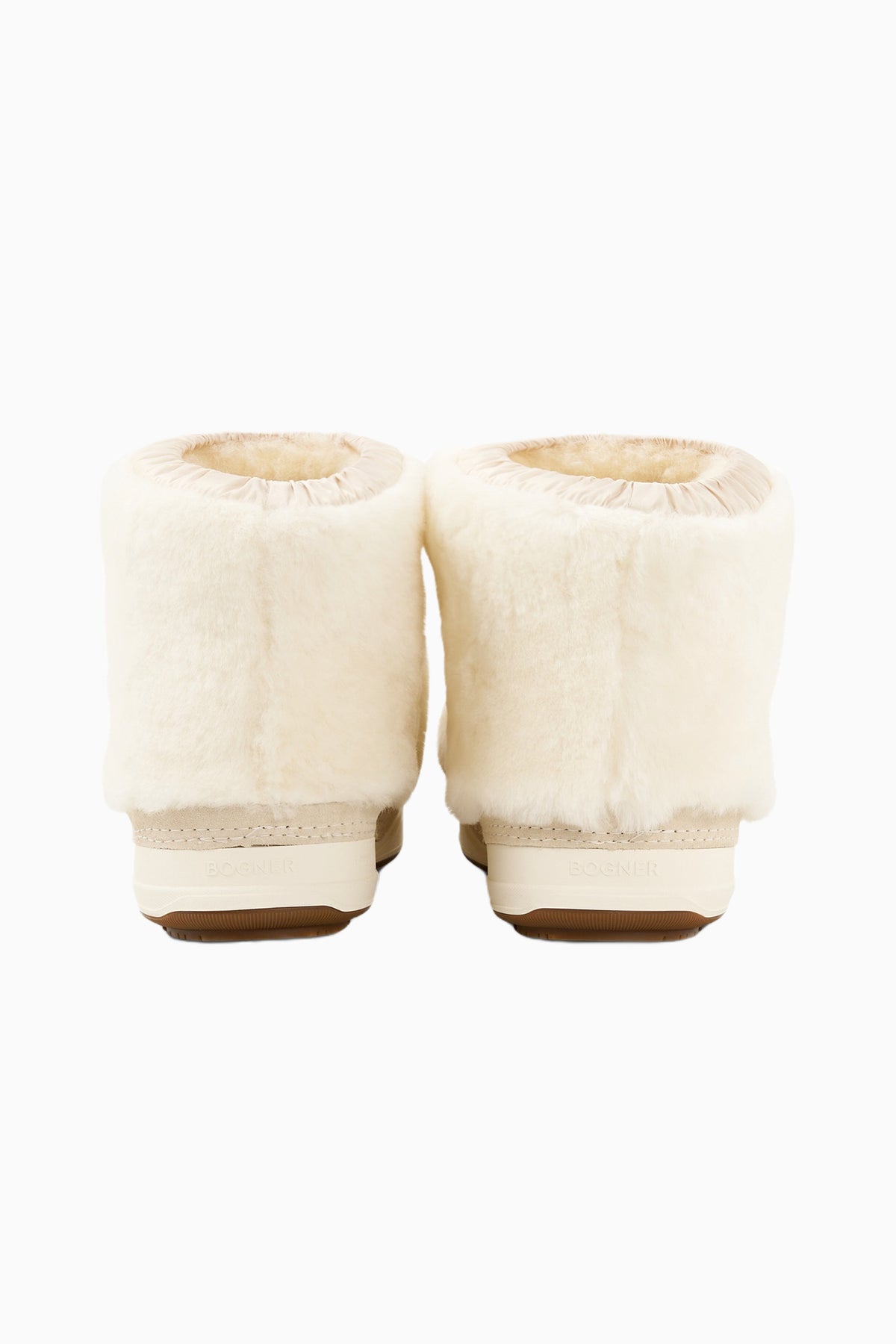 Pair of off-white faux-fur girls boots with rounded cuffs and brown rubber soles