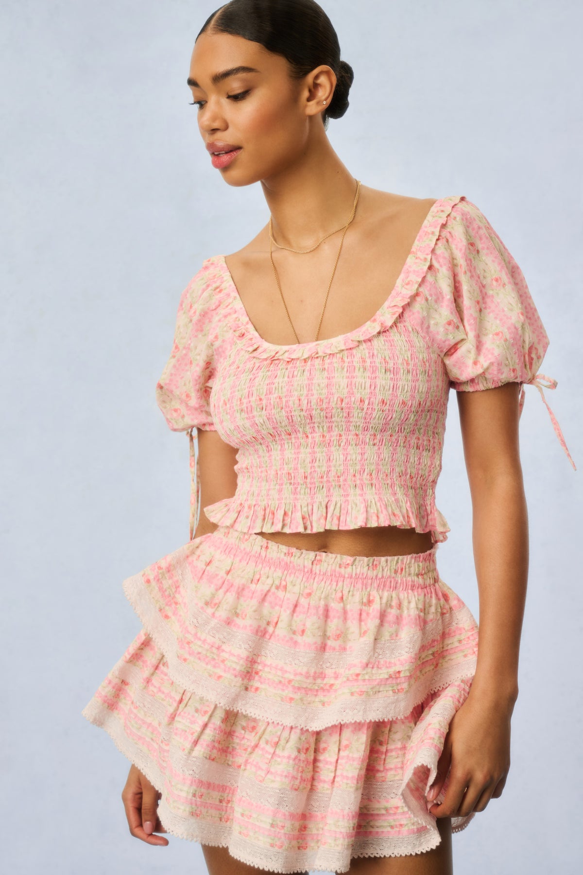 Pink floral smocked mini dress with puff sleeves and layered ruffle hem