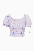Light blue printed smocked peplum top with puff sleeves and side tie details