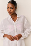 Embroidered cotton button-up shirt close-up, white collar with front button placket