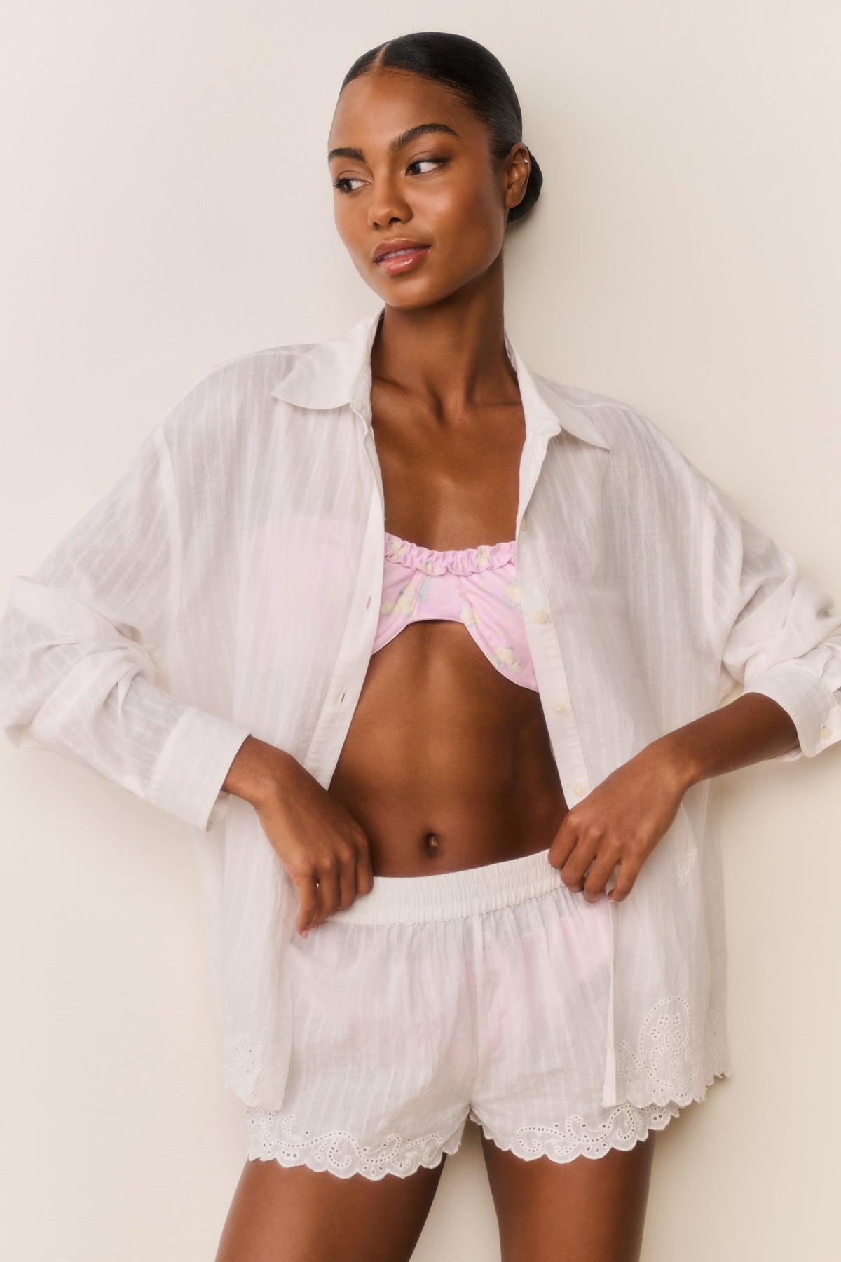 White cotton cover-up shorts with lace edges and decorative eyelet hem