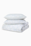 Embroidered duvet cover and sham set in light blue with subtle bow-style stitching