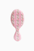 Pink floral mini detangling hair brush, oval shape with short handle