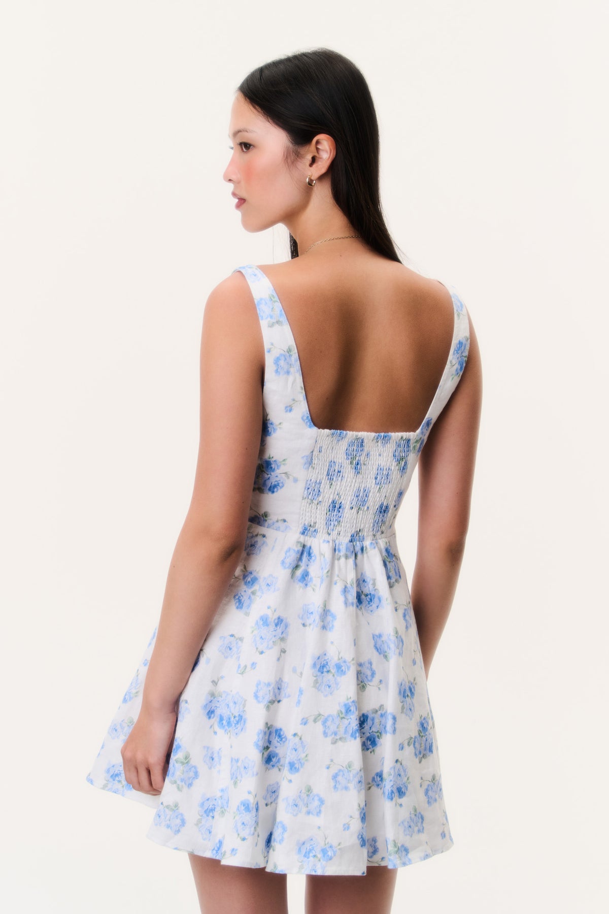 Blue floral linen mini dress with scoop-back design and flared skirt hem