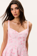 Pink floral linen mini dress with thin straps and fitted bodice detail