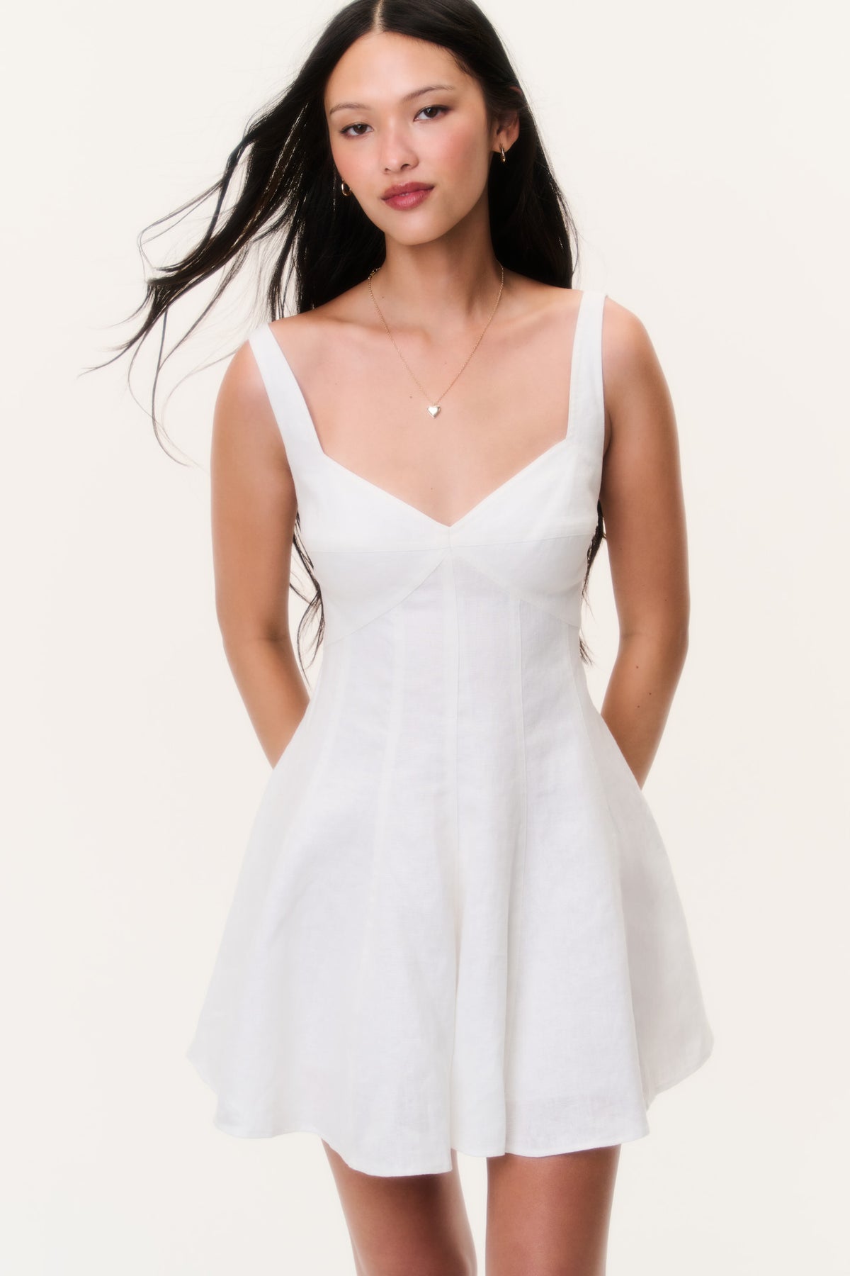 White linen mini dress with V neckline and spaghetti straps, front view