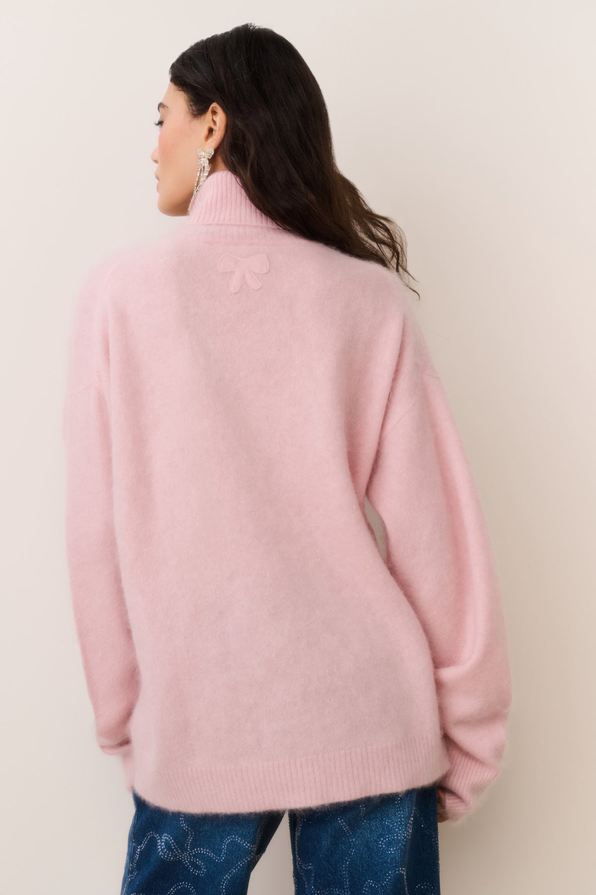 Pink cashmere turtleneck sweater, back view with ribbed hem