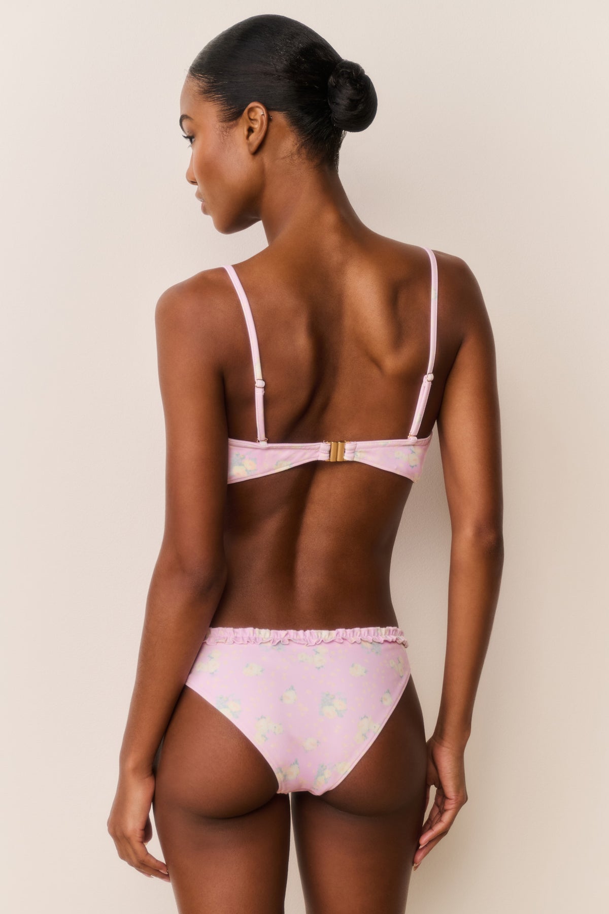 Pastel pink floral balconette bikini back view with thin adjustable straps and ruffled edges