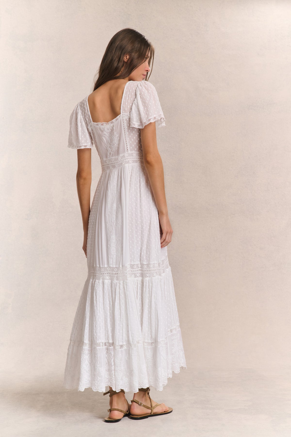 White maxi dress with square back neckline, tiered ruffle skirt, and short sleeves