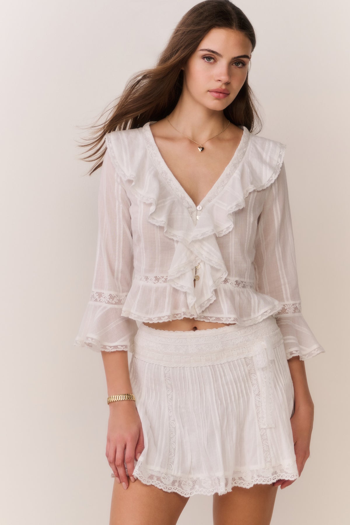 White cotton mini skirt with smocked waistband and scalloped lace ruffle hem