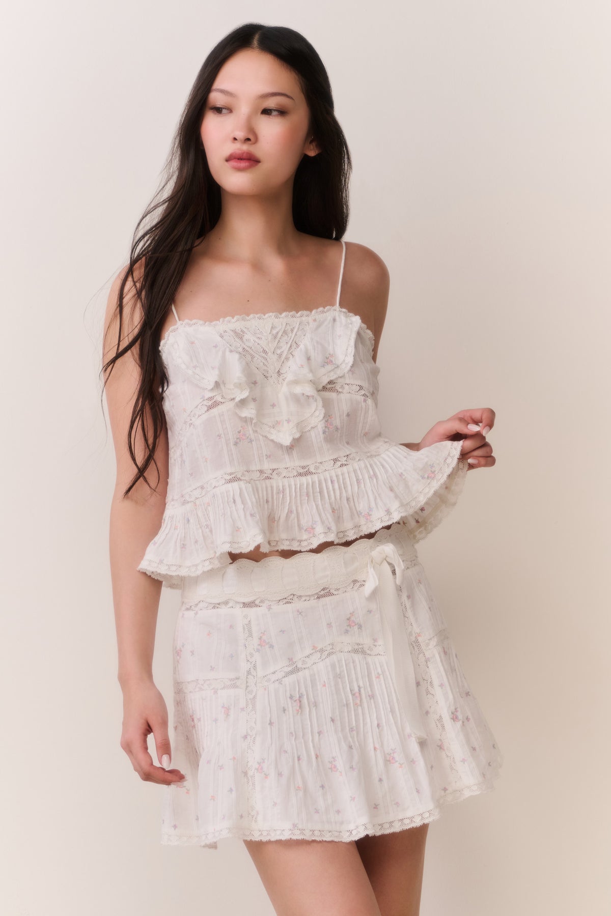 Floral embroidered cotton top with layered ruffles and thin spaghetti straps, light cream