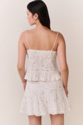 Floral embroidered cotton top with spaghetti straps and layered ruffle tiers, light cream