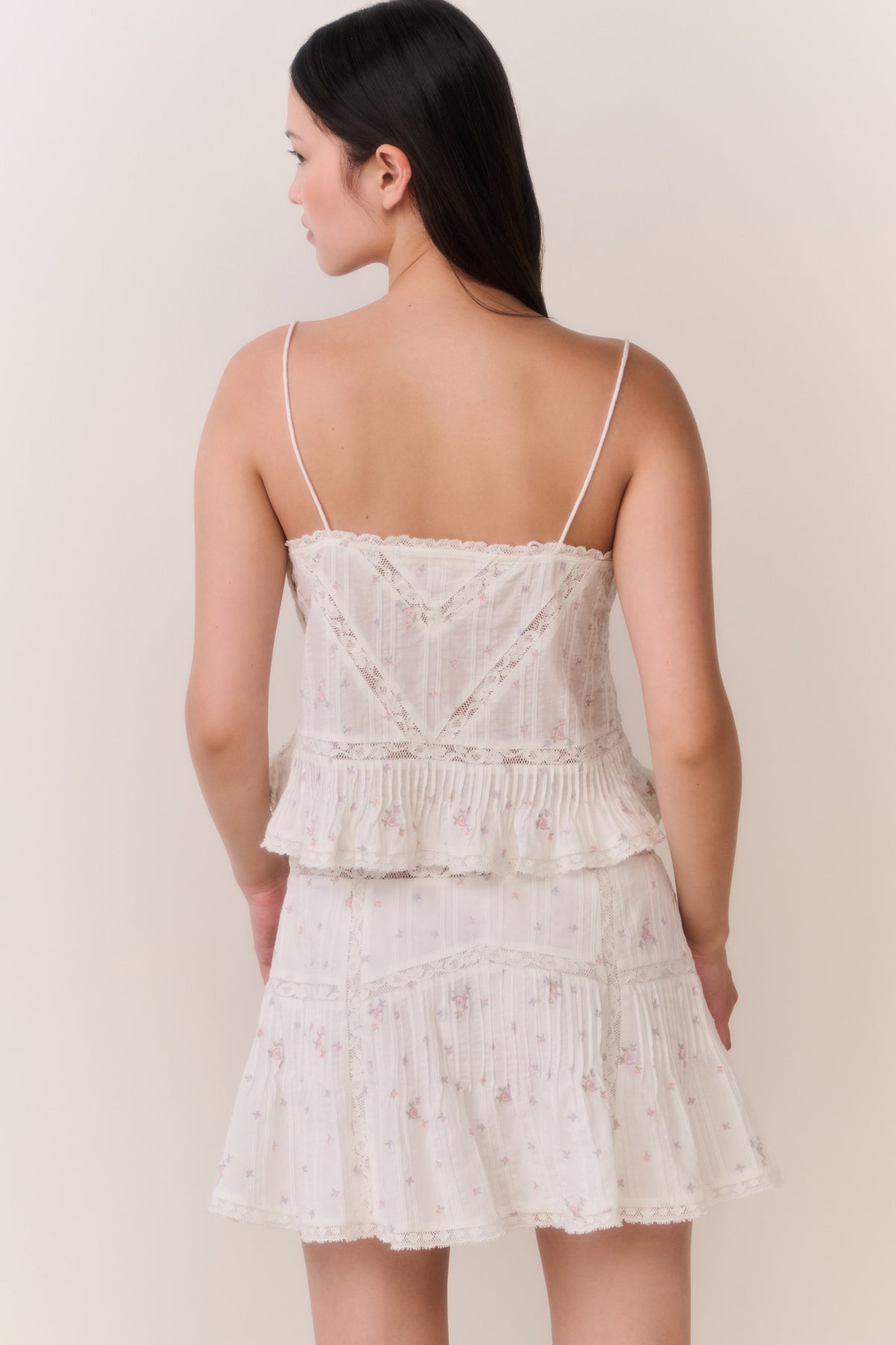 Floral embroidered cotton top with spaghetti straps and layered ruffle tiers, light cream