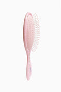 Pink floral paddle detangling brush with white bristles