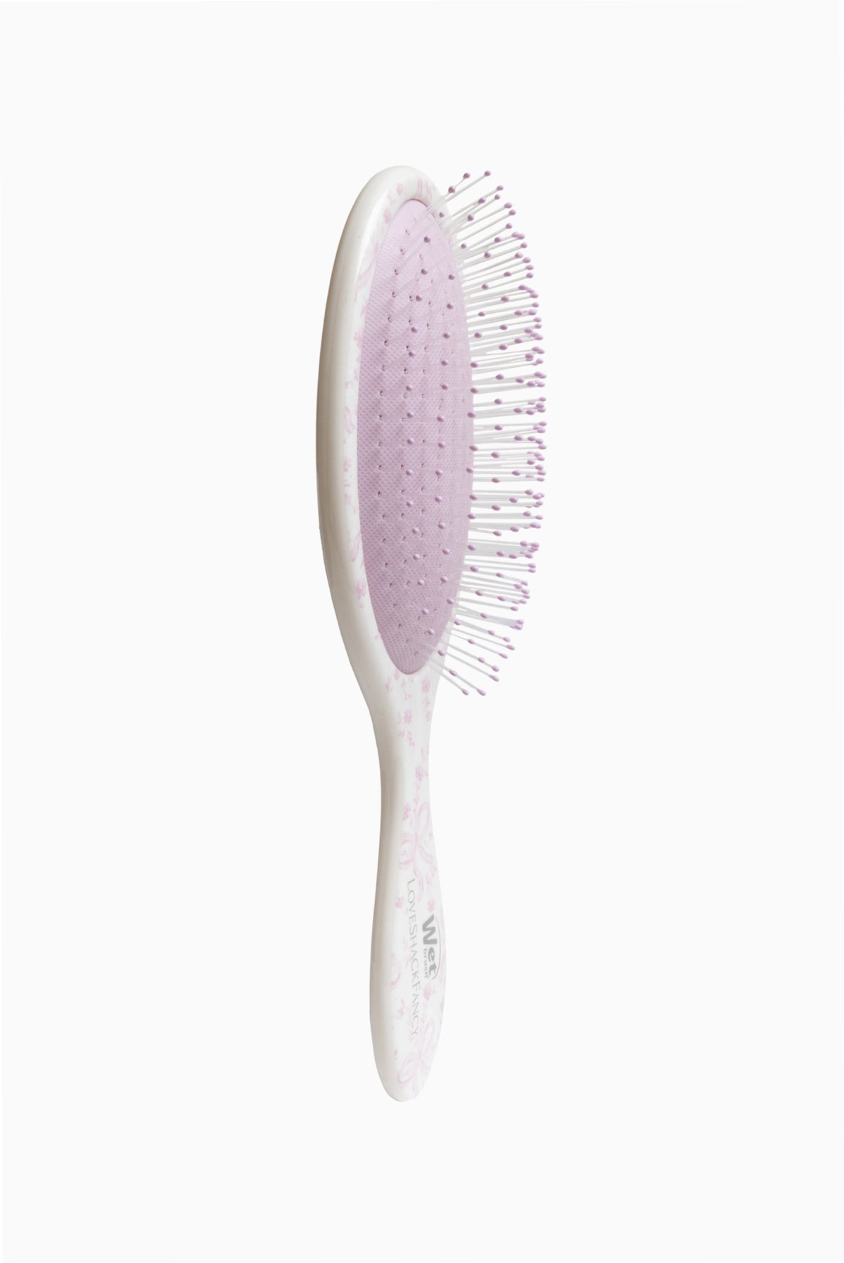Side view of pink oval detangling brush with white handle and bristles