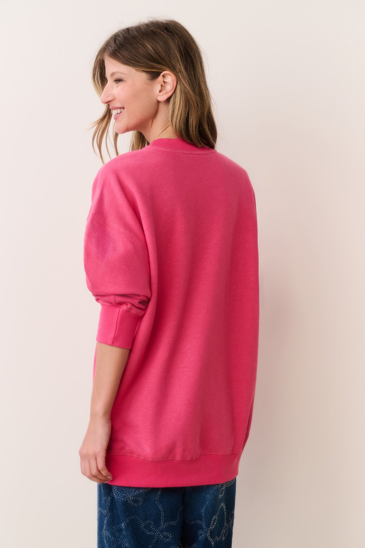 Location pullover sweatshirt in hot pink, back view with ribbed hem and cuffs