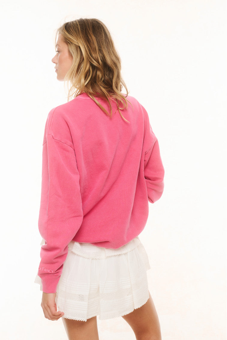 Pink crewneck pullover with long sleeves and relaxed fit, back view