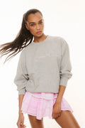 Gray pullover sweatshirt with long sleeves and small chest logo graphic