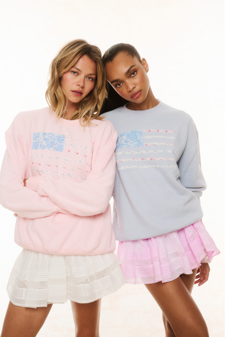 Pair of fleece pullovers: pink and light blue, crew necks with multicolor stripe graphics