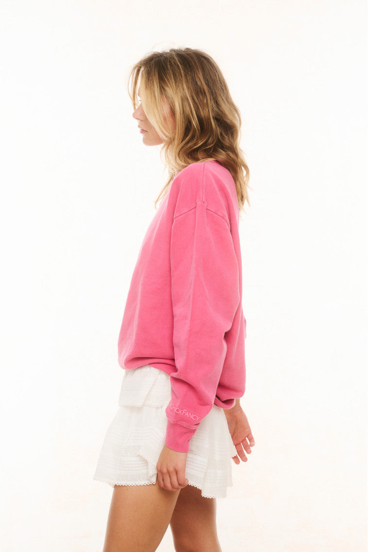 Pink crewneck pullover with long sleeves, side view, ribbed cuffs