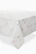 White patchwork table linen with pastel floral diamonds and blue stitched edge trim.