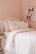 Light white duvet cover set with embroidered bow and matching sham, subtle dotted pattern