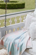 American flag-style blanket draped outdoors, pink/white stripes with blue field