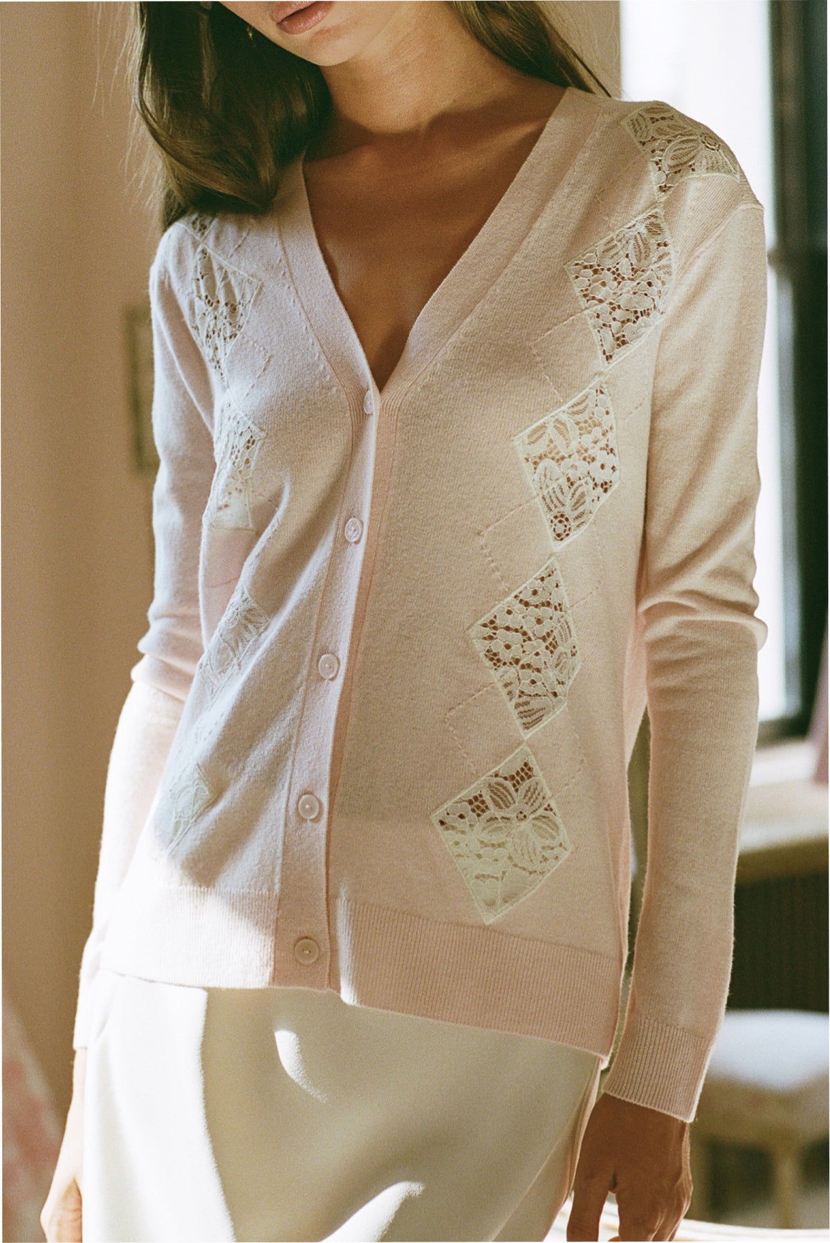 Light pink lace-panel wool cardigan with V-neck, button front, and long sleeves