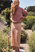 Rose-gold beaded midi skirt with scalloped lace hem, worn with heels