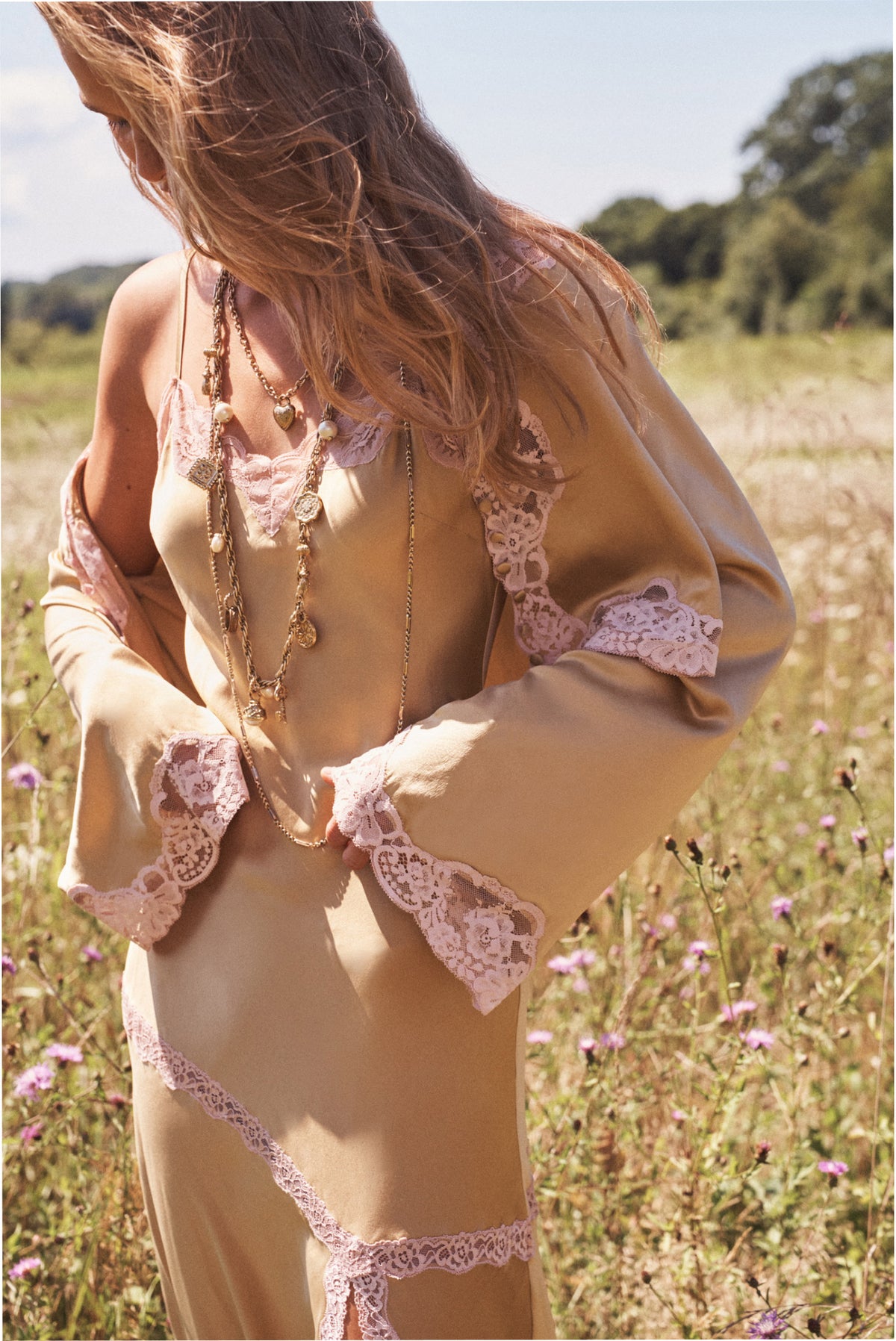 Silk lace top worn outdoors: light tan satin with pink lace back trim and long sleeves