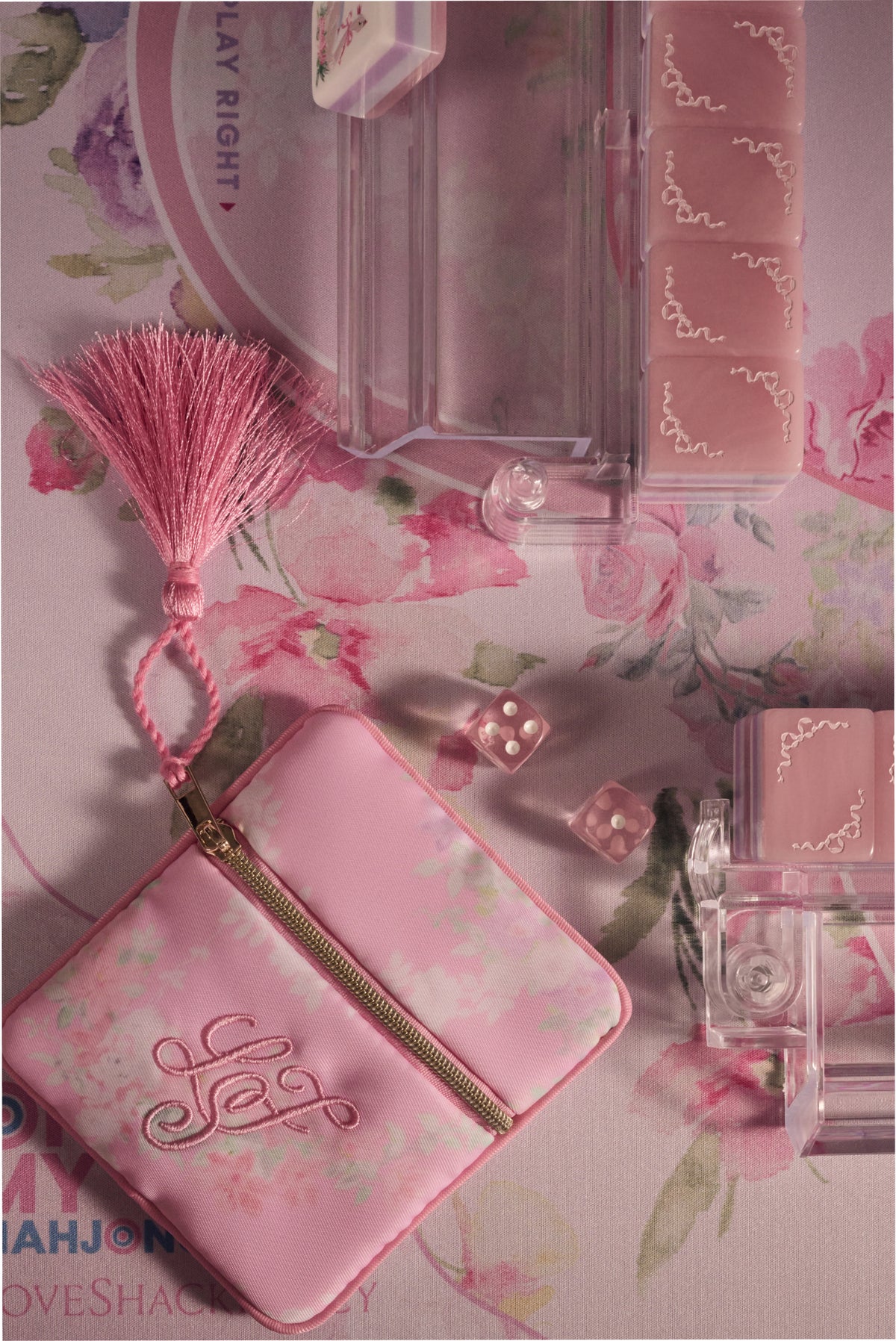 Pastel pink mahjong tile set with decorative motifs and matching accessories
