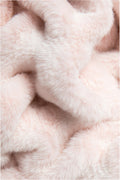 Detail shot of throw blanket in petal pink textured with a soft, frosted finish