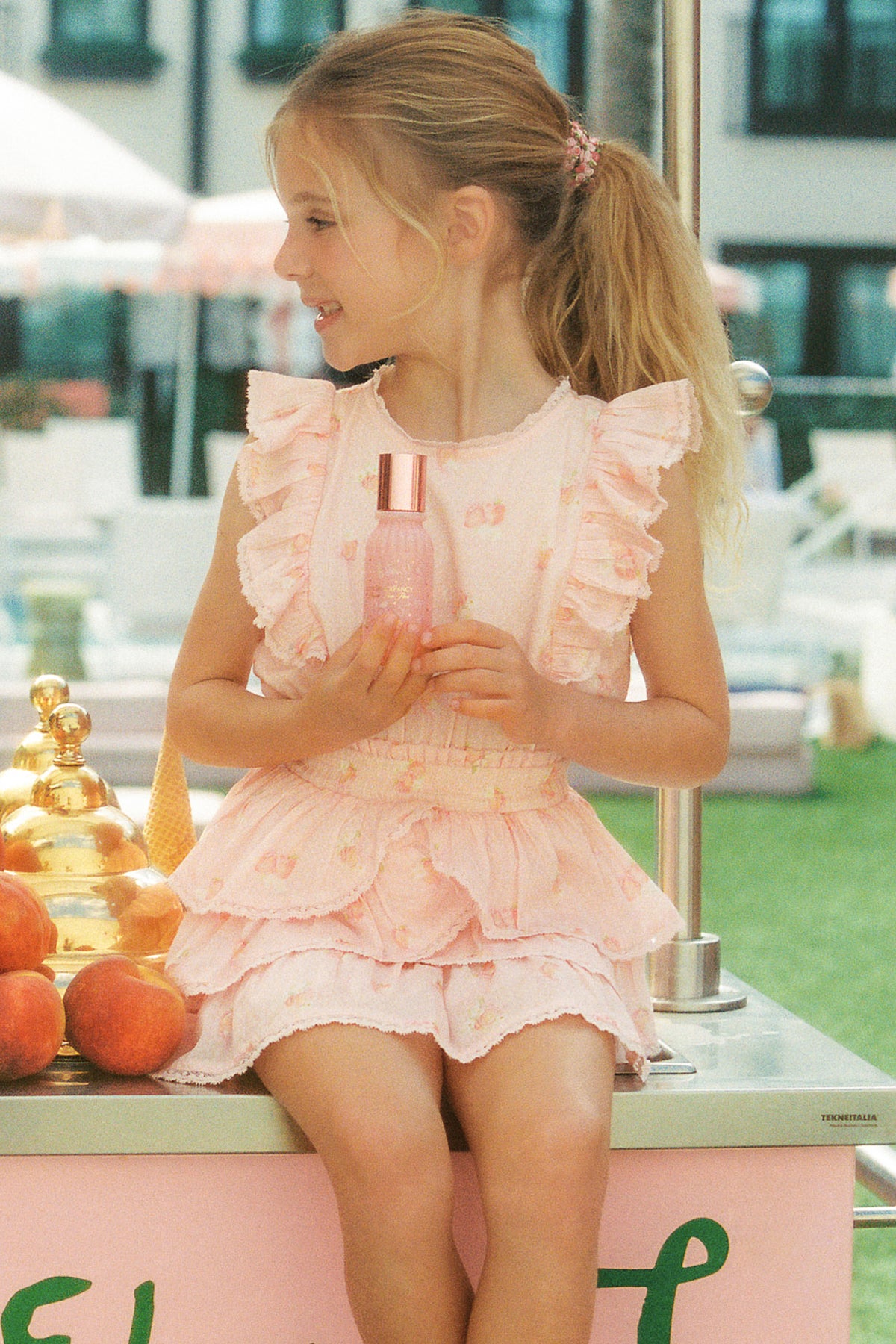 Girls peach ruffle mini dress with layered skirt and short ruffled sleeves