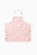 Kids pink printed apron with neck strap, front tie, and ruffled edges