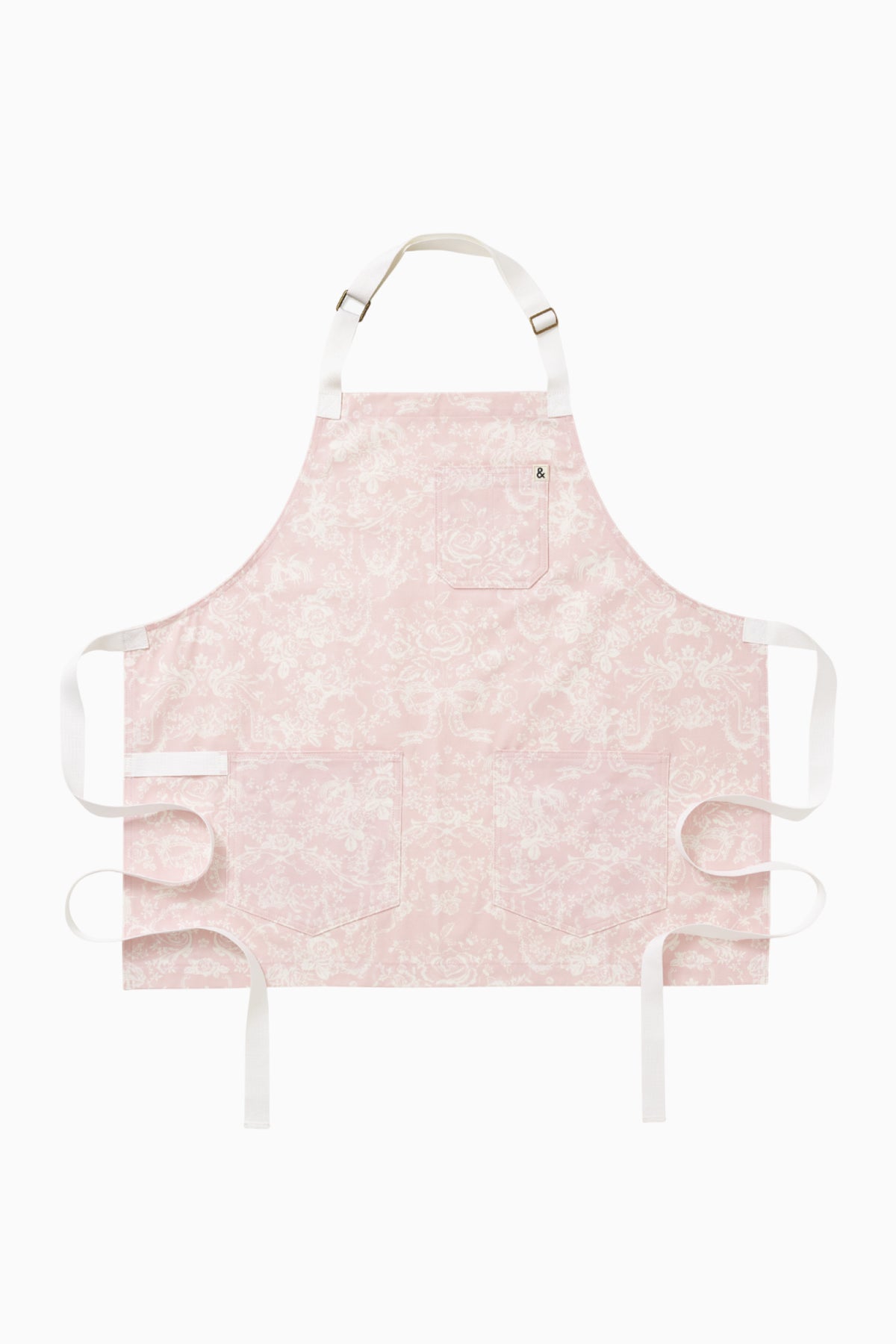 Perennial pink printed apron, front flat lay with adjustable straps and ties