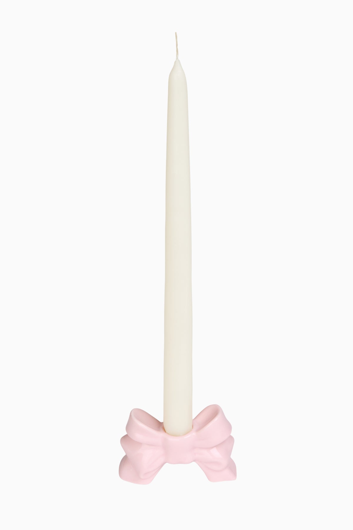 Pink porcelain bow candlestick holder with white pillar candle